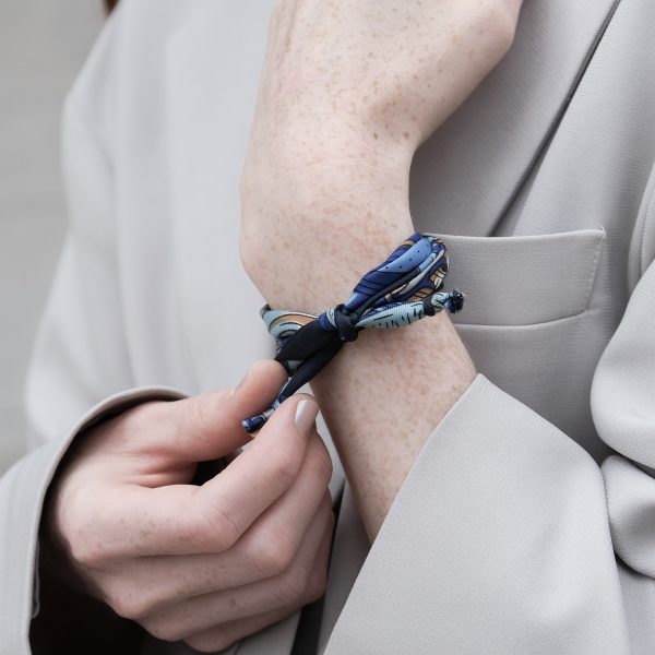 Handgelenk mit blaugemusterten Seidenarmband